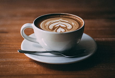 foam art in white teacup with spoon closeup photography thumbnail