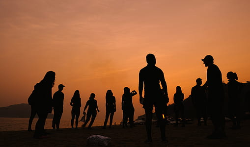 silhouette of persons standing beside the seashore thumbnail