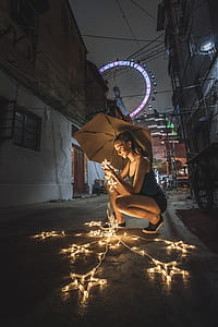 woman holding star lights outdoors thumbnail