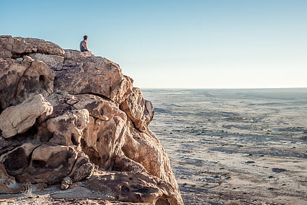 man on cliff during daytime thumbnail