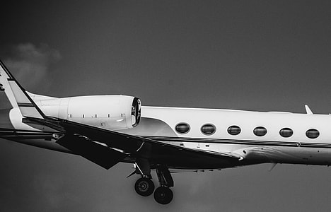 grayscale photo of an airplane on midair thumbnail
