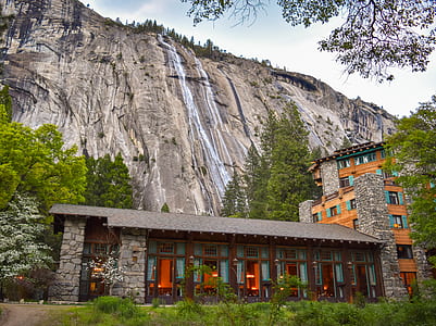 waterfalls behind building surrounded by trees thumbnail