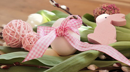 white and pink Easter bunny-themed decoration on green leaf thumbnail