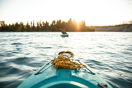 teal sit-on-top kayak on body of water photo thumbnail