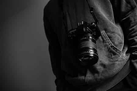 grayscale photo of DSLR camera with lanyard thumbnail
