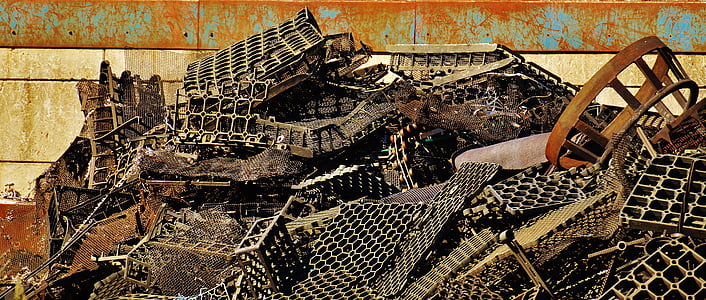 pile of gray scrap parts near wall thumbnail
