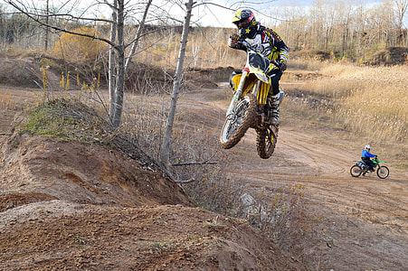 motocross rider jumping over hill thumbnail
