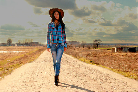 woman walk-through in the middle of road under cloudy sky during daytime thumbnail