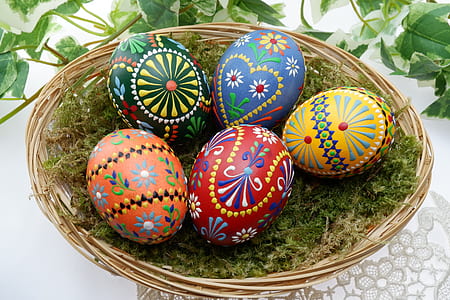 several assorted-color Easter eggs on brown wicker basket thumbnail
