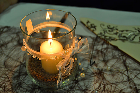 candle inside clear glass holder thumbnail