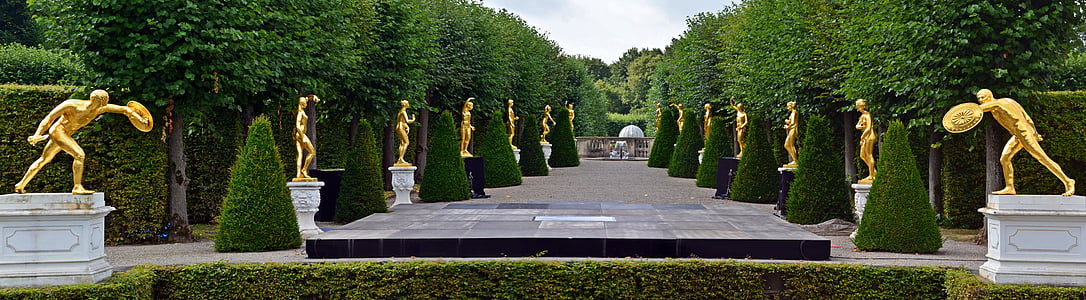 statues beside green trees during nighttime thumbnail