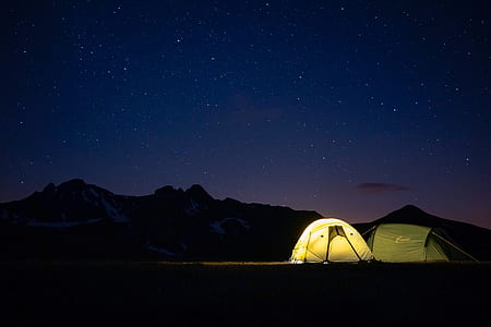 two grey and white dome tents under starry night thumbnail