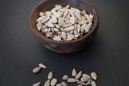 round brown container with gray seeds thumbnail