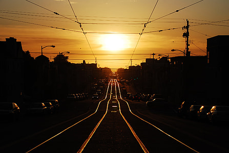 black roadway in between of car lot at golden hour thumbnail