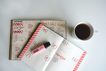 white ceramic cup near pink marker thumbnail