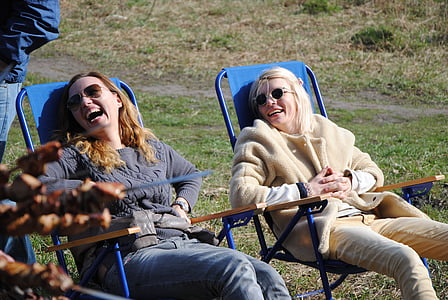 two women sitting on armchair thumbnail