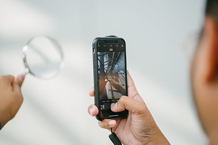 Person Taking Photo Of Magnifying Glass thumbnail