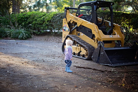Toddler Stand Beside Front Loader thumbnail