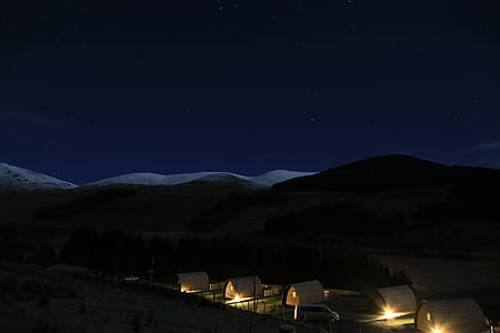 landscape of mountain and houses during night thumbnail