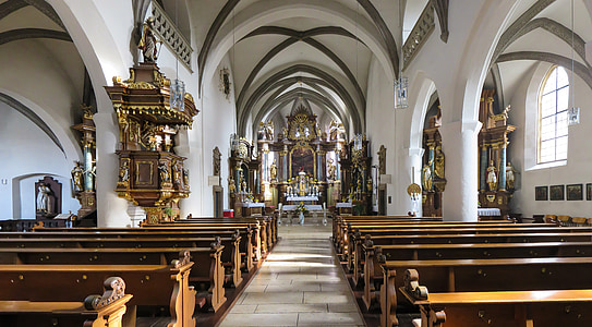 pile of brown pew benches inside cathedral thumbnail
