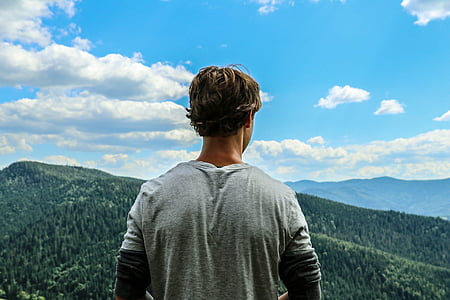 man standing in front of mountain thumbnail