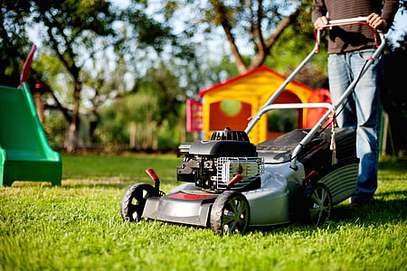 selective-focus photography of gray bagging push mower thumbnail