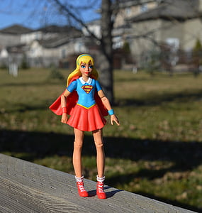 Super Girl action figure on grey balustrade thumbnail