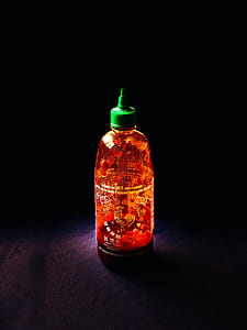 clear and green labeled bottle on blue cloth thumbnail
