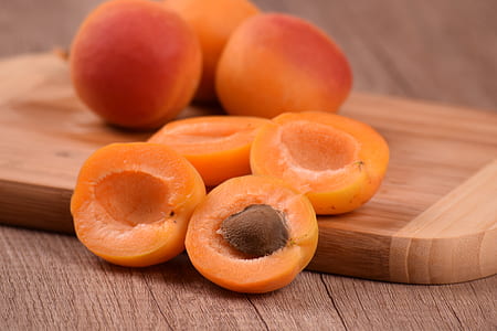 slices of peaches on wooden chopping board thumbnail
