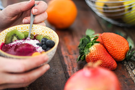 person holding bowl of mixed fruits thumbnail