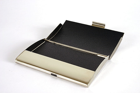 opened gold-colored clutch on white surface thumbnail