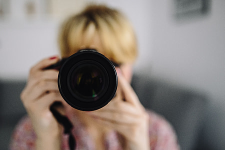 Woman in pink with her camera thumbnail