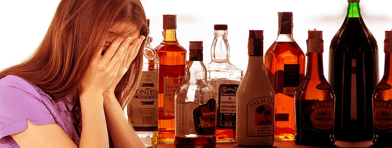 woman in purple shirt near bottle thumbnail