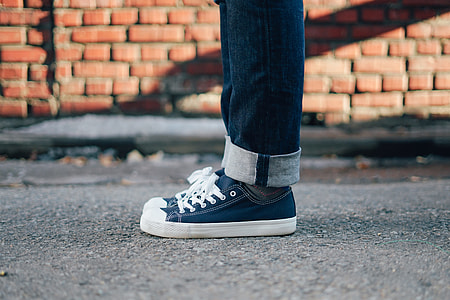 person wearing blue-and-white low-top sneakers thumbnail