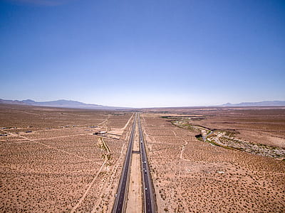 two gray road in the middle of the dessert thumbnail