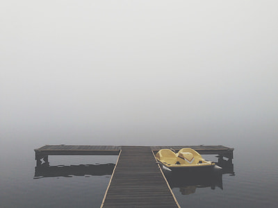 brown wooden dock near yellow boat on body of water thumbnail
