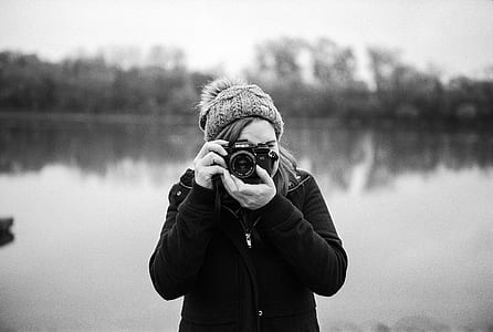 shallow focus photography of woman taking photo thumbnail