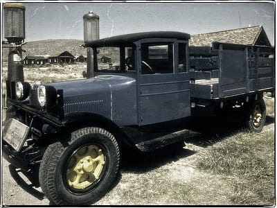 classic gray cargo truck parked beside building thumbnail