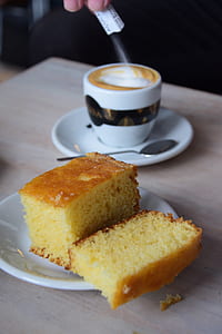 person pouring sugar on latte thumbnail