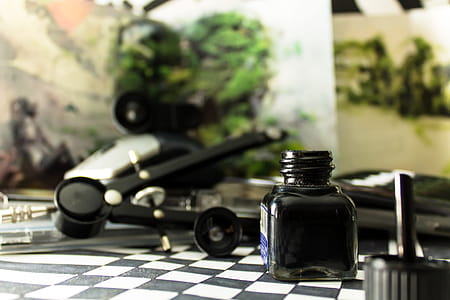 Black Glass Bottle on White and Black Checked Board thumbnail