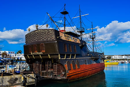 black and red ship beside dock thumbnail