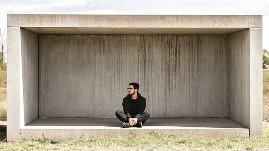 man sitting on gray concrete shed thumbnail