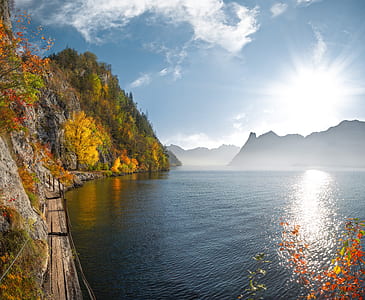 body of water beside mountain thumbnail