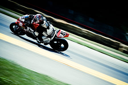 person riding motocross bike on road at daytime thumbnail