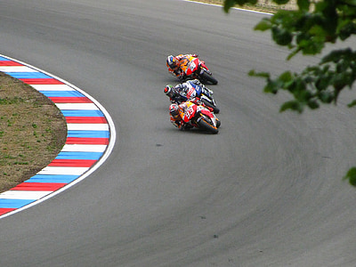 three person riding on sports bike on race track thumbnail