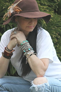 close-up photo of woman wearing white crew-neck t-shirt and distressed blue denim jeans thumbnail