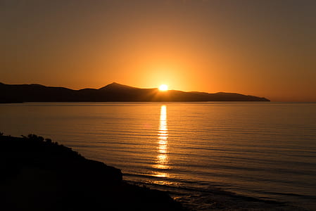 sunrise overlooking body of water thumbnail