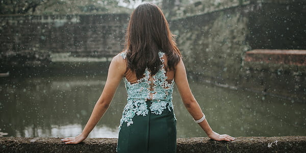 woman leaning on gray concrete ledge thumbnail