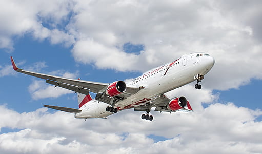 white and red flying airplane thumbnail