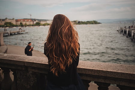 women wearing black on bridge facing body of water thumbnail